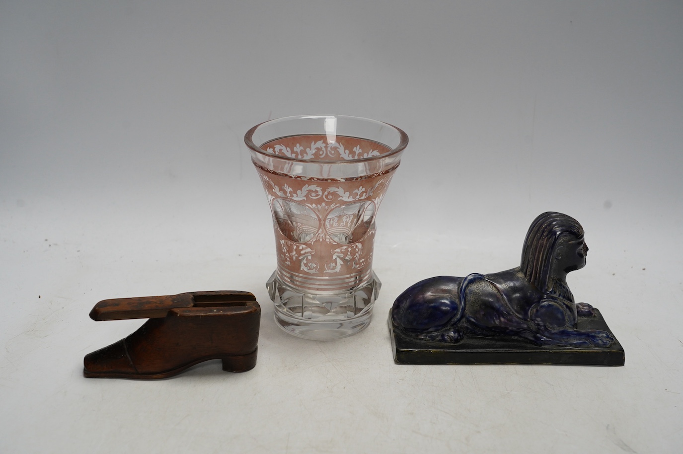 Sundry items comprising a Victorian flashed cut and engraved beaker, a 19th century model of a sphinx, and a green shoe snuff box. Condition - fair